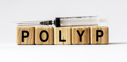 Text POLYP made from wooden cubes. White background