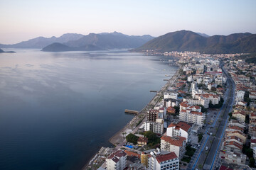 Fototapeta na wymiar View over resort town of Marmaris, Turkey. Landscape with sea, buildings and mountains. Popular tourists destination.