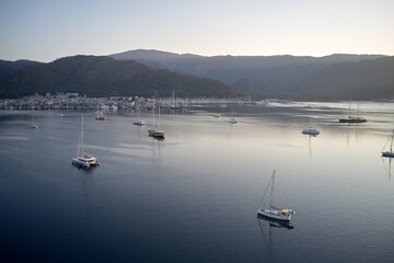 Yachting marina of resort town of Marmaris, Turkey. Ships in the sea harbor on the background of...
