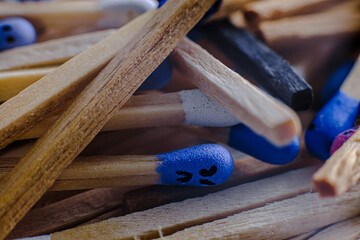 Macro view of the Multicolored matchsticks with faces painted on the heads