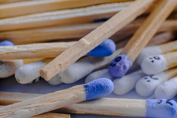Macro view of the Multicolored matchsticks with faces painted on the heads