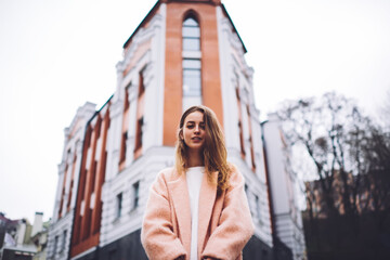 Fototapeta premium Young female on street near building