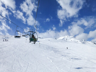 Beautiful shot from a ropeway with the cloudy sky from above and the snowfield from bellow in winter