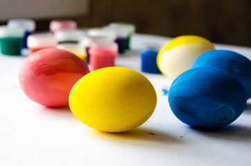 Fototapeta na wymiar blue yellow pink eggs on white background at easter