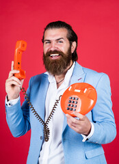 well groomed man in wedding formalwear has beard use retro phone, call