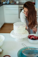 Young beautiful woman bakes a cake. Sweets. Confectionery.
