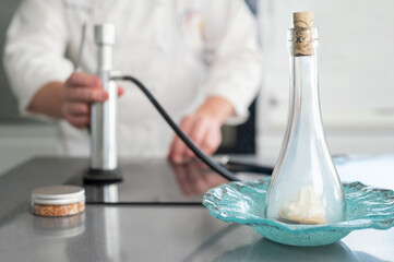 fine restaurant chef, smoking a plate with sophisticated kitchen utensils. High quality photo.