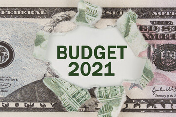 The dollar is torn in the center. In the center it is written - Budget 2021