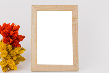 photo frame on white background with branches of red and yellow leaves