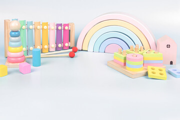 Kids toys collection. Wooden rainbow, educational and music baby toys on light blue background