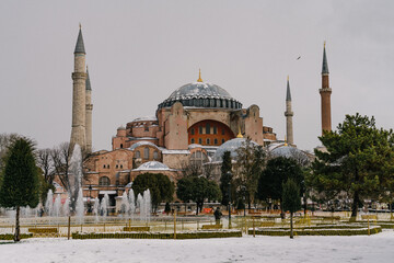 Fototapeta premium Istanbul winter a day. St. Sophia Cathedral in snow.People walking in Sultanahmet District under snow.