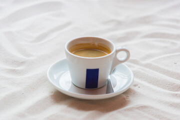 white cup with hot coffee on the table