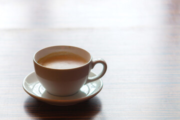 white cup with hot coffee on the table