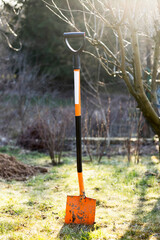 orange shovel spade in the garden