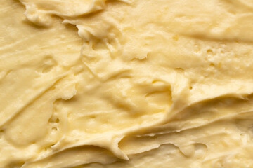 Yellow cosmetic cream body butter texture background.