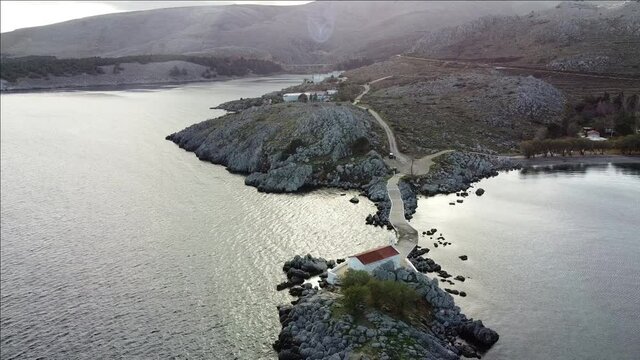 Aerial view of Agios Isidoros chapel, a church on an imaginary islet at Chios Island, Greece