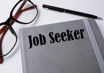 Pen and book with job seeker wording.