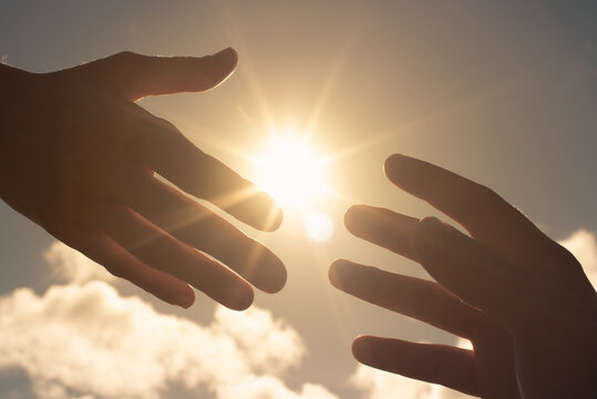 Giving helping hand on sun flair sky. 