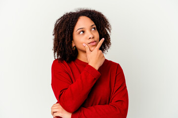 Young african american mixed race woman isolated thinking and looking up, being reflective,...