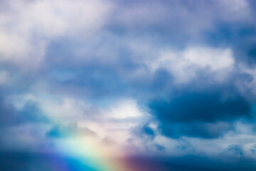 Clouds and Rainbow in Close Up of Sky in Muted Soft Background - 414237163