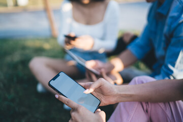 Cropped image of female using cellphone for writing mail message during online chatting in social networks, selective focus on mockup smartphone gadget with copy space area for internet advertising