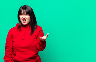 plus size pretty woman looking angry, annoyed and frustrated screaming wtf or what’s wrong with...