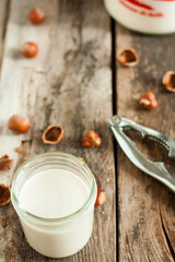 Nut milk on a wooden background
