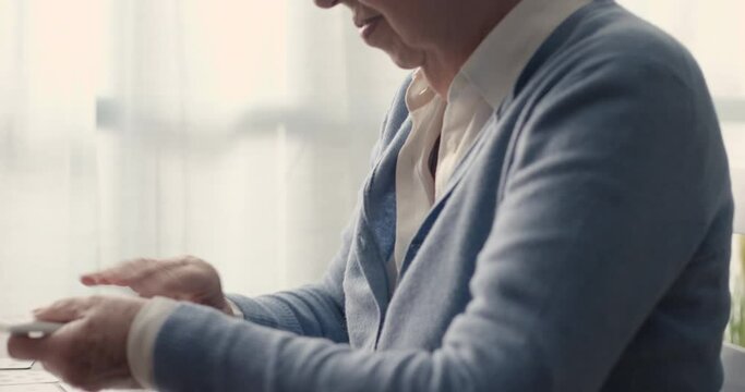 Senior woman playing solitaire