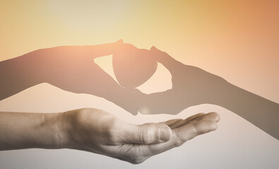 Hand holding heart giving love and help to someone in need. 