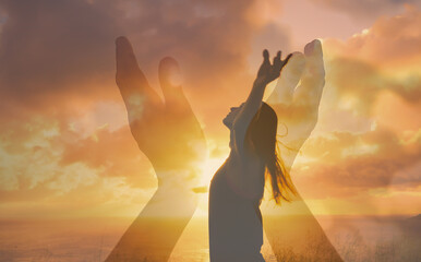 silhouette of a woman with arms up in the sunset Hands reaching out to sky, warm rays of sunshine....