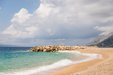 Beautiful pier, benches and emerald sea water. Brela Croatia, Makarska riviera