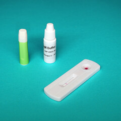 Test result using a rapid test device for new coronavirus. Covid-19 rapid antibody test kit on a blue background. 