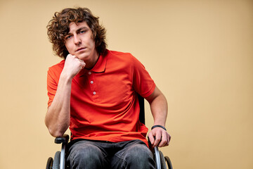 tired invalid man want to recover and get back on feet, sits on wheelchair exhausted looking at...