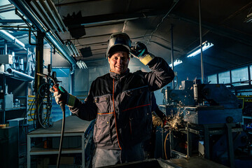 Fototapeta na wymiar Portrait of a welder posing in a workshop