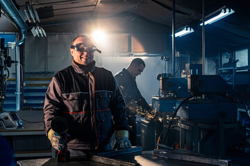 Portrait of the grinding handyman posing in the workshop