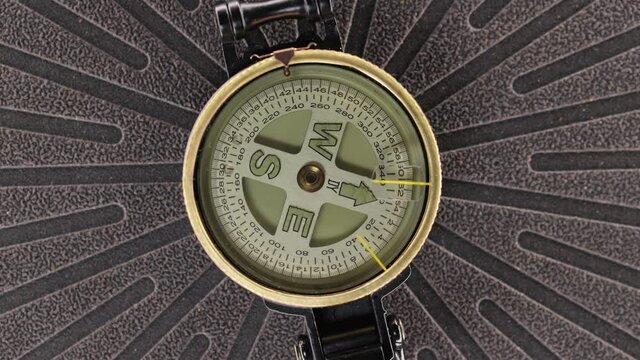 Magnetic compass spinning around close up