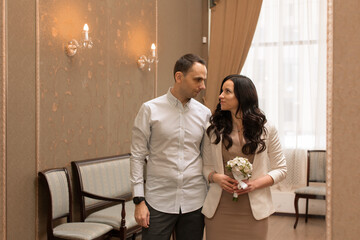 Beautiful and happy newlyweds marry each other and get married. New family and marriage. Registration at the registry office