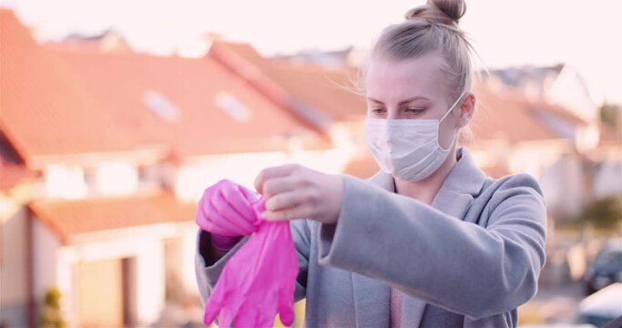 Woman Wearing Purple Protective Gloves and Protective Mask.