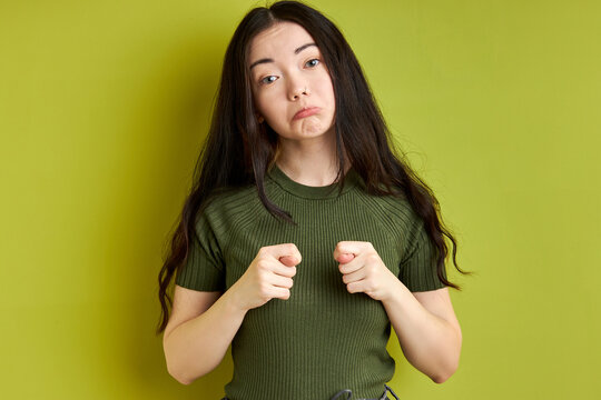 woman hand showing fig sign isolated on green background, you don't get it anyway. portrait