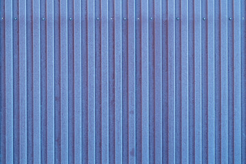 texture of a shaped fence made of blue metal. the metal sheet is covered with frost