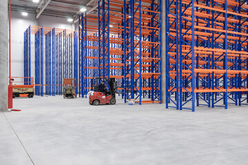 steel shelves rack in new modern large warehouse. loader next to the racks. nobody. no people.