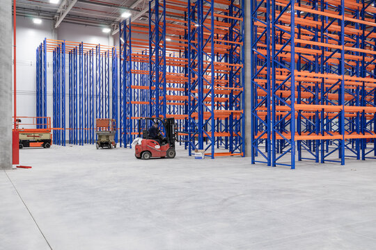 Steel Shelves Rack In New Modern Large Warehouse. Loader Next To The Racks. Nobody. No People.