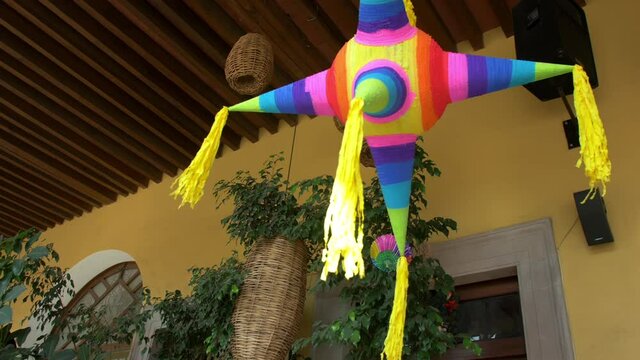 Colorful pinata and handmade lamps hanging from the ceiling