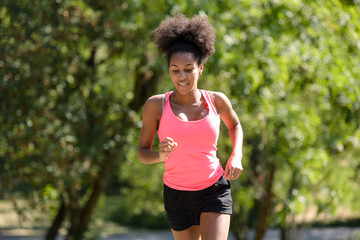 young metis woman running in a park