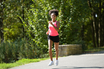 young metis woman running in a park