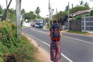 Young backpacker walks on street of Sri Lanka