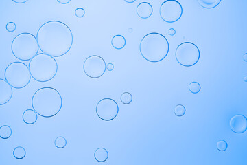 Creative neon background with drops. Glowing abstract backdrop with vibrant gradients on bubbles. Blue overflowing color