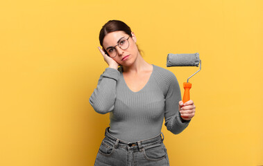 young pretty woman feeling bored, frustrated and sleepy after a tiresome, dull and tedious task,...