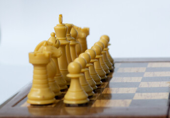 White pieces formed on a chess board © ResiLente