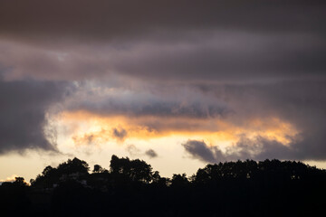 Silhouette of trees and clouds at sunset outdoors in rural Guatemala, inspiration reflection of heavenly creation.